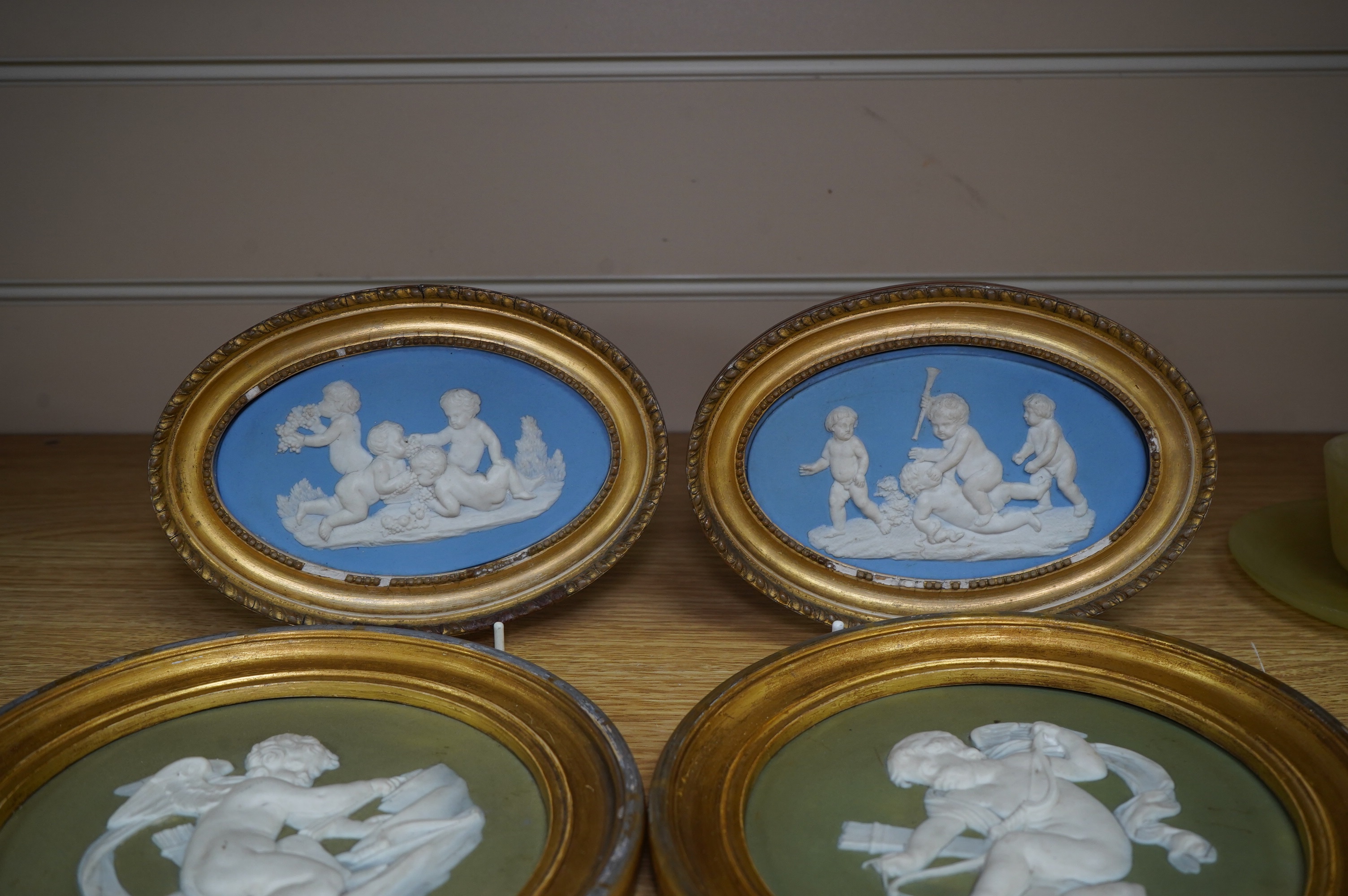 Two pairs of jasperware plaques, probably Wedgwood, in gilt frames, largest 19cm in diameter. Condition - fair to good
